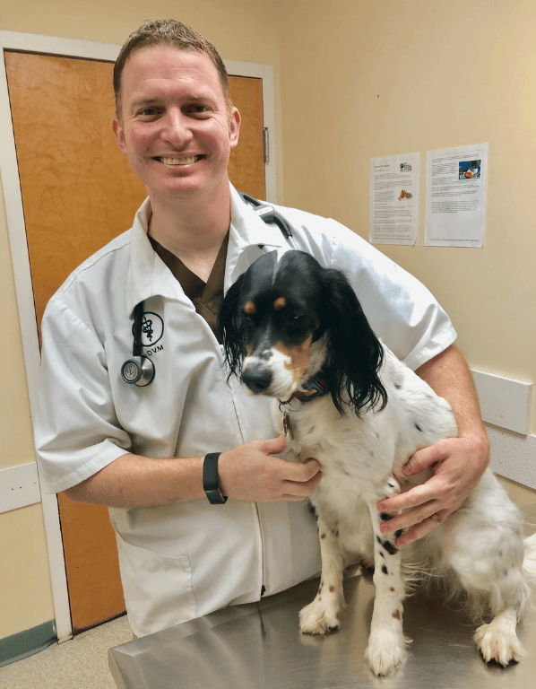 Lead DVM and Founding Veterinarian, Brad Stock posing with dog